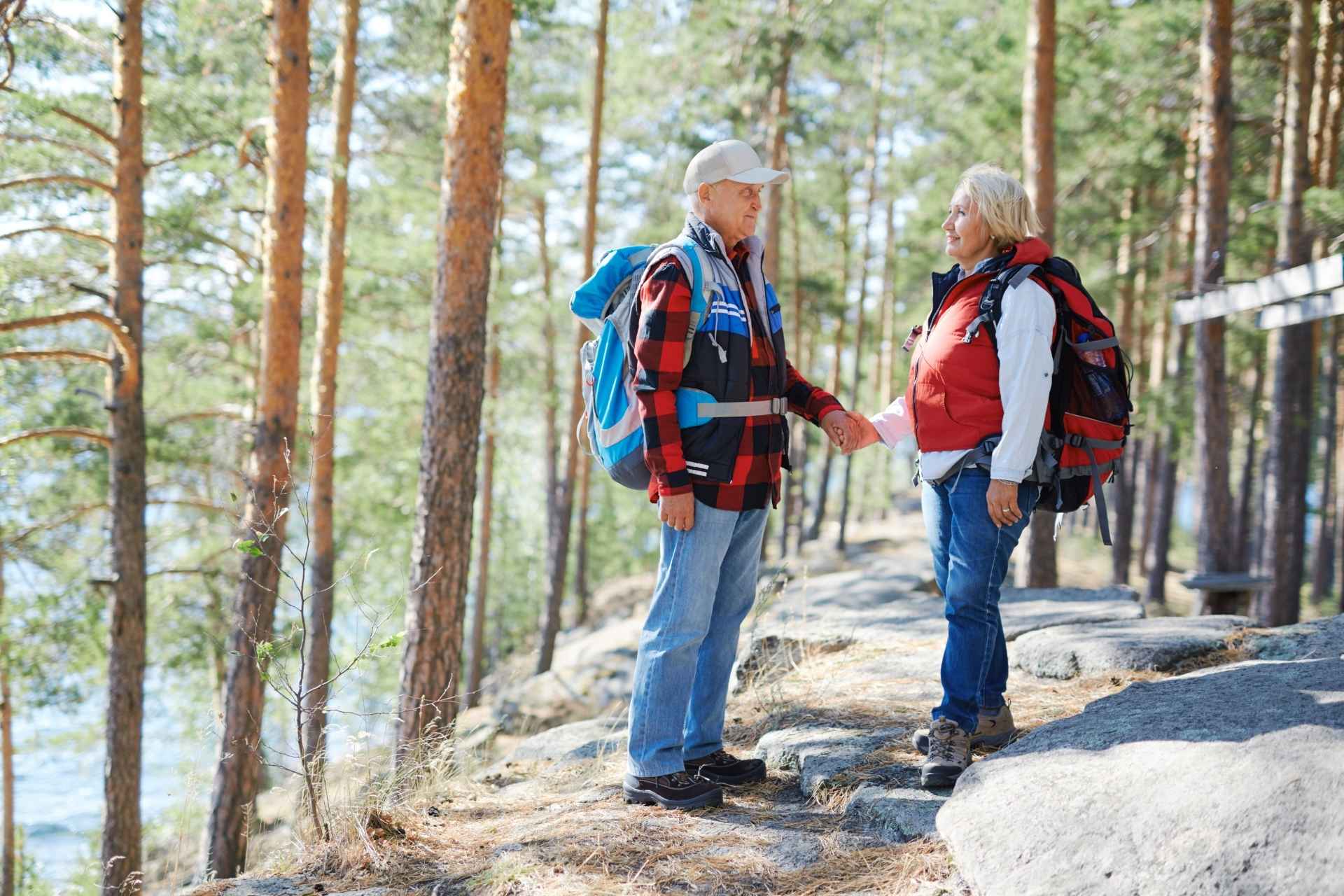 Two seniors enjoying a beautiful hike together.